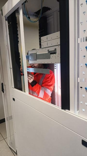 Técnico instalando rieles dentro de un gabinete